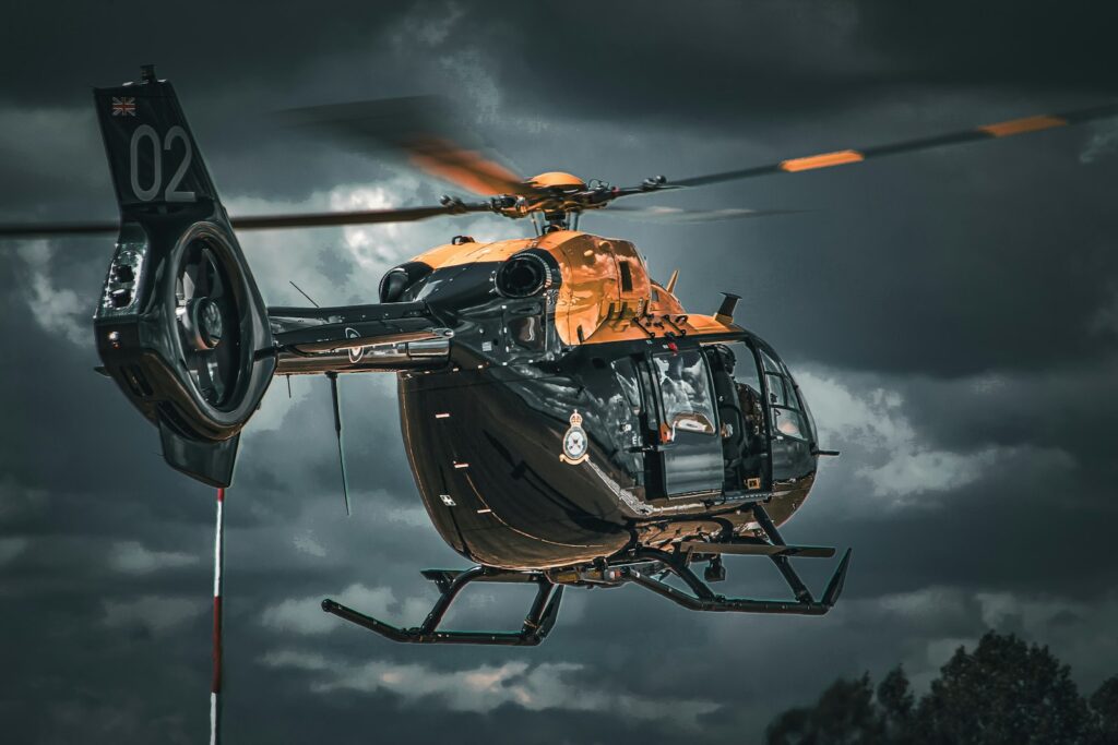 a helicopter flying through a cloudy sky on a cloudy day